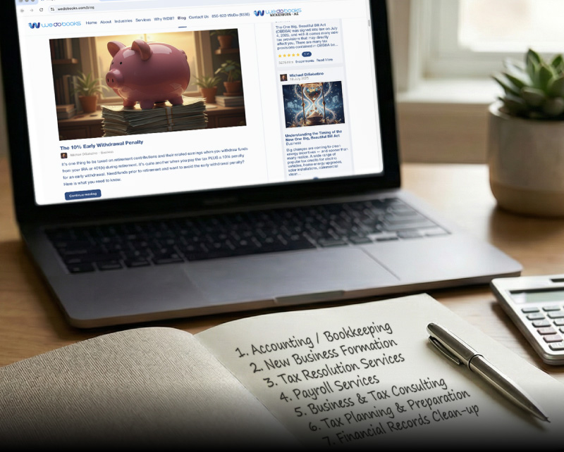 Close-up of a wooden desk with an open notebook listing accounting services, a calculator, stacked folders, a laptop displaying the We Do Books website, and a small plant in warm natural light.